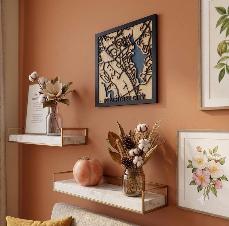 Layered wood map of Peachtree City in a black frame
