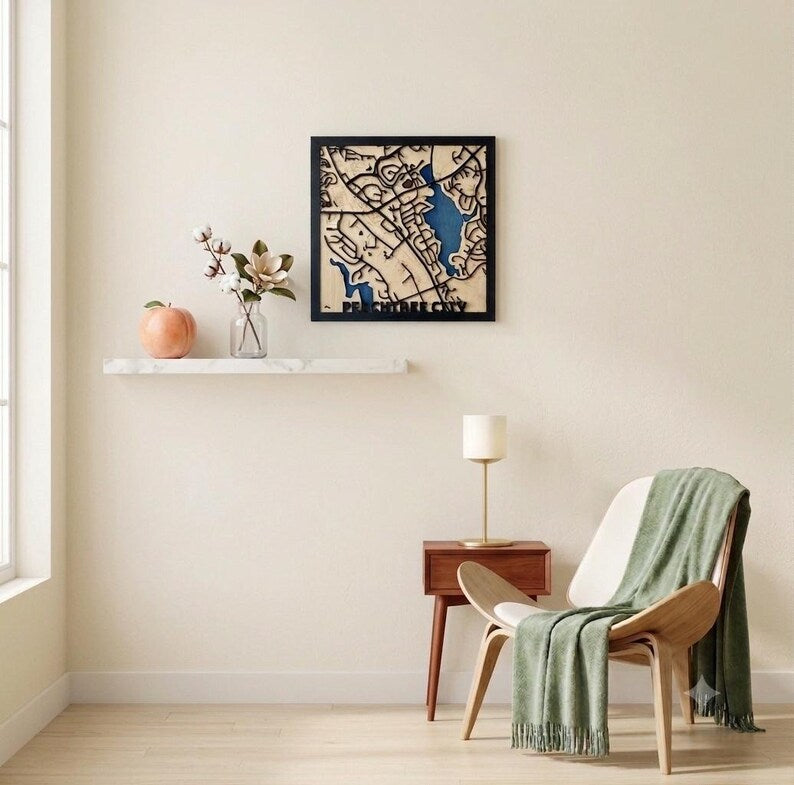 Peachtree City wood map hanging above a floating shelf